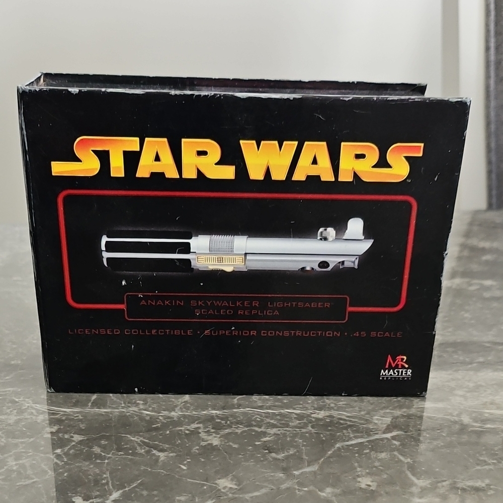 Star Wars Silver and Black Lightsaber Replica without the stand.